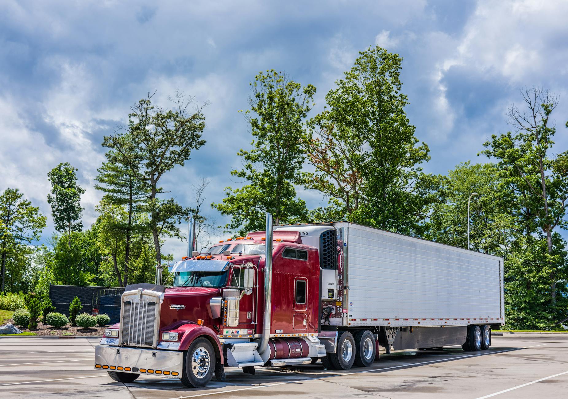 powerful red semi truck in scenic parking area